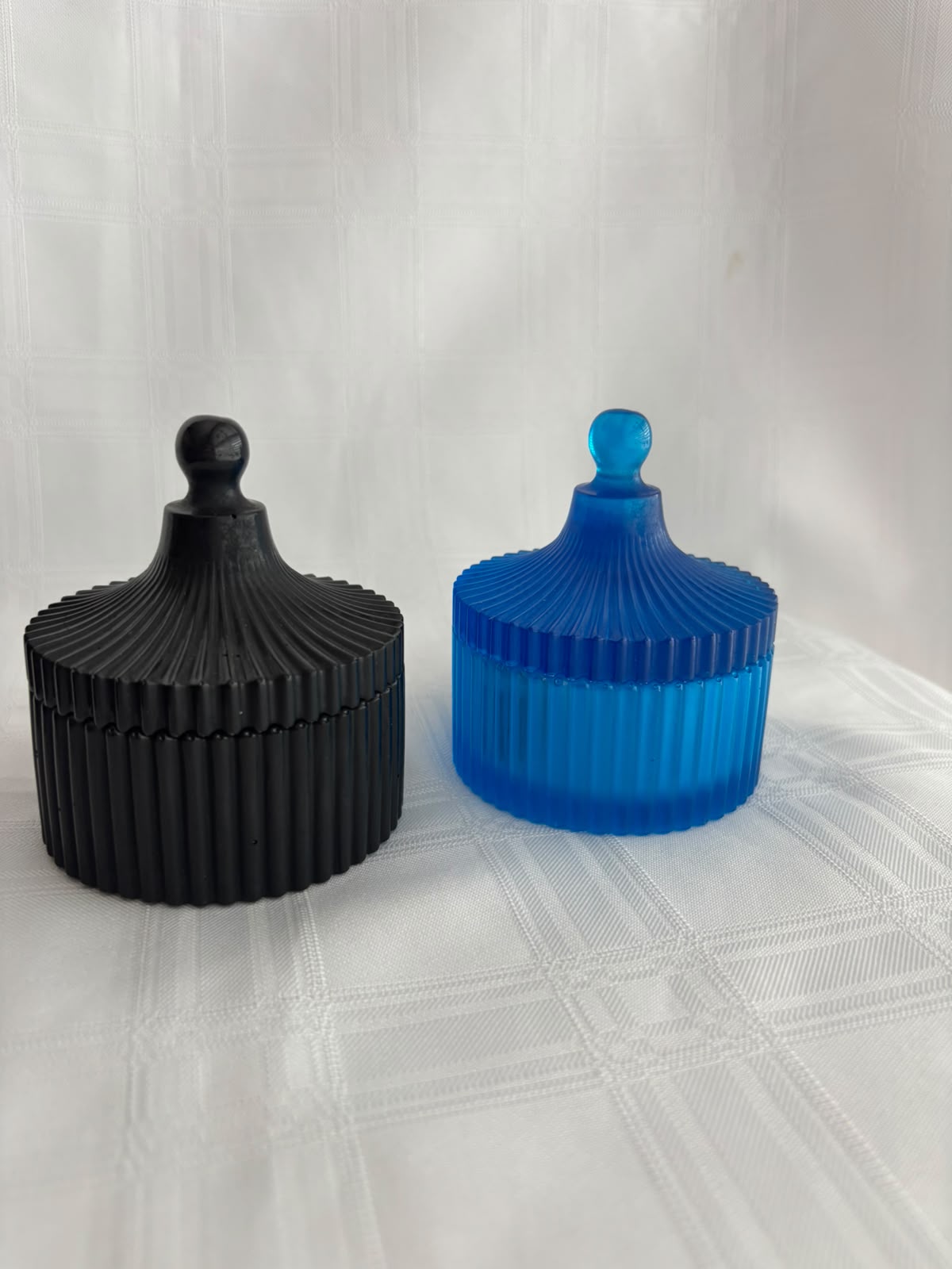 Two ribbed resin trinket boxes with finial lids, matte black and bright blue